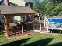 New deck next to a swimming pool - different angle showing a roofed in section